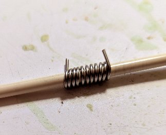 Wire wrapped around knitting needle